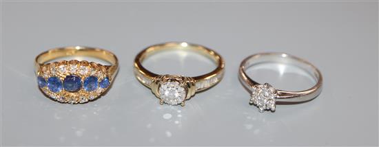 An 18k gold sapphire and diamond three row dress ring, a small diamond cluster ring and another ring